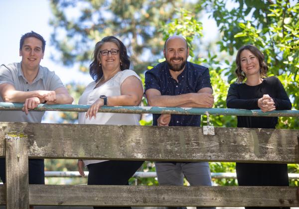 four happy recruiters by a railing